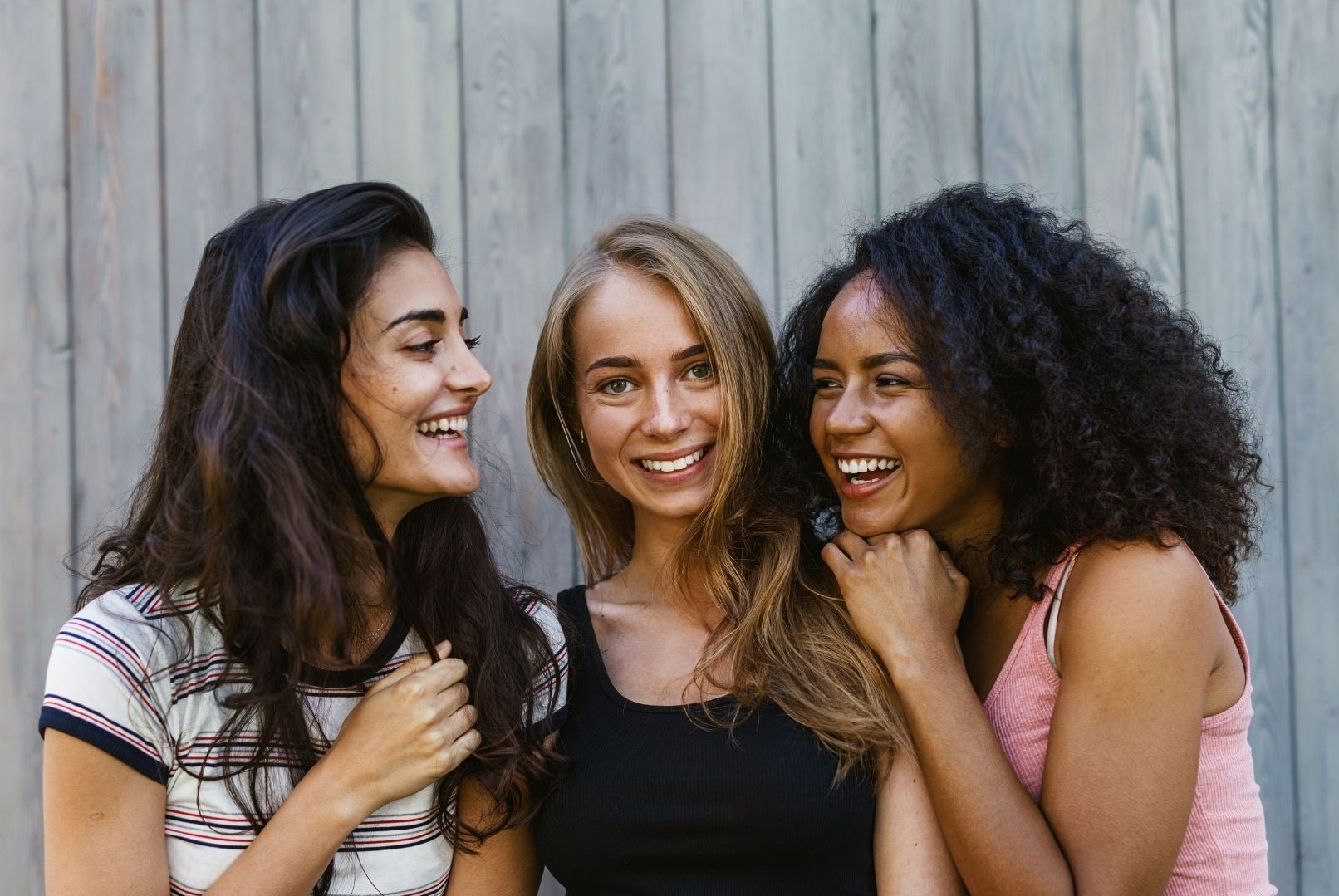 three women laughing together