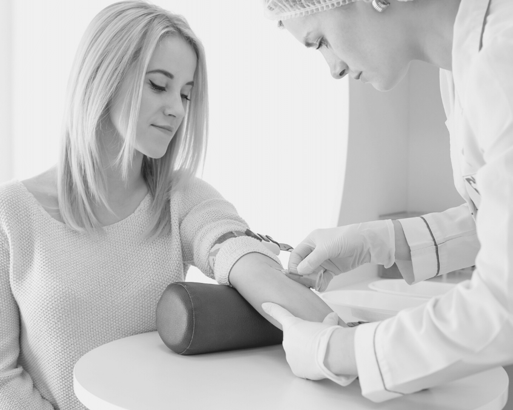 Lady having blood test - corporate customer with nurse